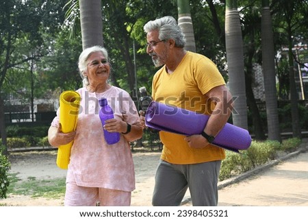 Portrait of an Indian old couple walking in park
