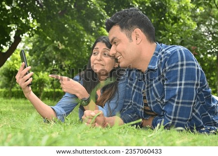 Similar – Man holding hot dog in barbecue with friends