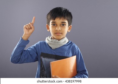 Portrait Of Indian School Boy With Textbook