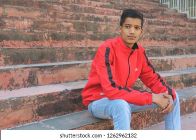 Portrait of an Indian teenager in a red jacket. India, Rishikesh, December 19, 2018.