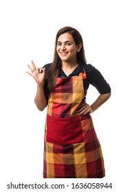 Portrait Of Indian Woman Chef Or Cook In Apron, Presenting, Pointing, With Ok Sign, Thumbs Up Or Hands Folded. Standing Isolated Over White Background