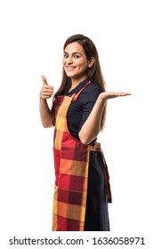 Portrait Of Indian Woman Chef Or Cook In Apron, Presenting, Pointing, With Ok Sign, Thumbs Up Or Hands Folded. Standing Isolated Over White Background