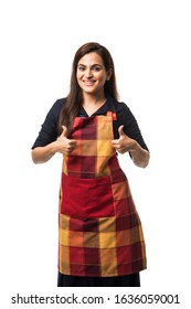 Portrait Of Indian Woman Chef Or Cook In Apron, Presenting, Pointing, With Ok Sign, Thumbs Up Or Hands Folded. Standing Isolated Over White Background