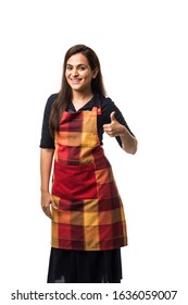 Portrait Of Indian Woman Chef Or Cook In Apron, Presenting, Pointing, With Ok Sign, Thumbs Up Or Hands Folded. Standing Isolated Over White Background