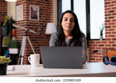 Portrait Of Indian Woman Working Remotely From Home On Laptop At Desk, Browsing Internet And Sending Email With Paperwork Report. Using Computer To Study Online At Class Webinar, Freelancer Work.