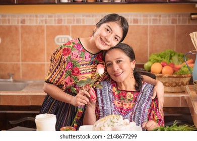 Portrait Of Indigenous Mother And Daughter Looking At Camera.