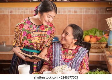 Portrait of indigenous women cooking together in the kitchen.