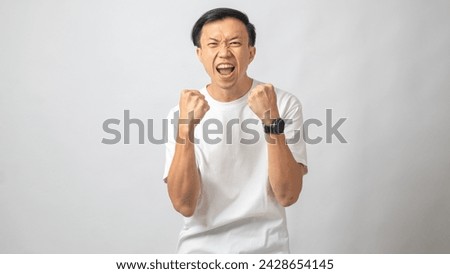 Portrait of an Indonesian Asian man, wearing a white T-shirt, posing in a 