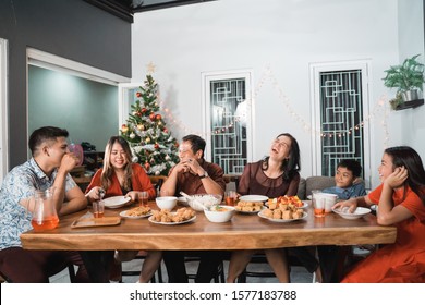 Portrait Of Indonesian Family Having Christmas Eve Dinner Together At Home