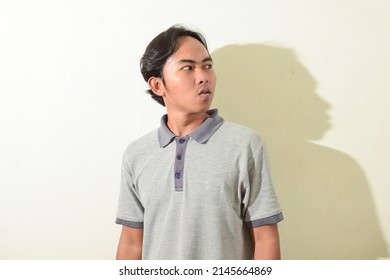 Portrait Of An Indonesian Man. An Asian Man's Flat Facial Expression. Portrait Of Indonesian People On White Background Isolated