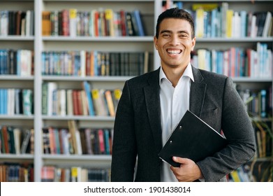 Portrait Of Influential Hispanic Male Business Leader. Attractive Entrepreneur Looks At The Camera And Smiling, Show Confidence And Success