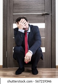 Portrait Of An Insecure Man Sitting Near The Office Door