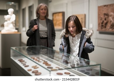 Portrait of interested cheerful preteen girl looking at exposition in historical museum.. - Shutterstock ID 2154428019