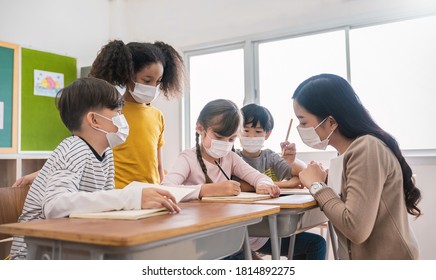 Portrait Of International Caucasian And Asian Students Teacher Wearing Face Mask In Group Study, Self-protect From Corona Virus After Lockdown. New Normal, Back To School Concept