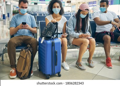 Portrait Of International Group Of Traveling Wearing Protective Masks Spending For Catch A Flight