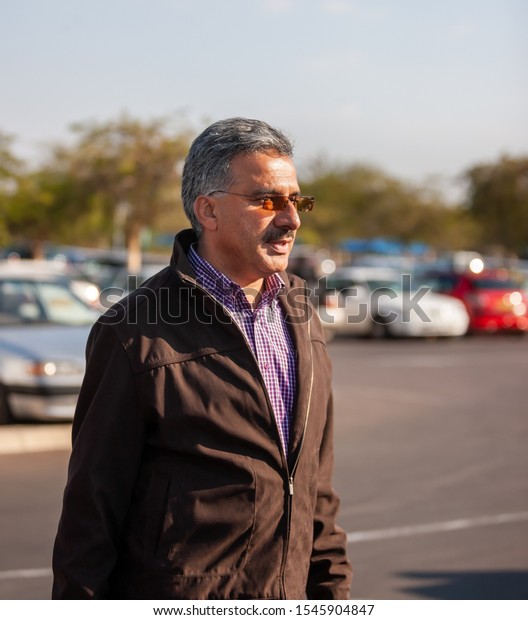Portrait of an\
Iranian Arabic business man\
smiling