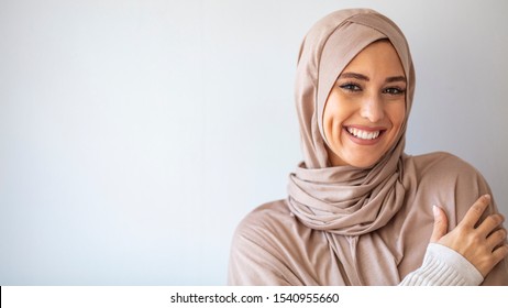 Portrait of islamic woman smiling. Pretty muslim girl. Beautiful asian muslimah woman model posing on grey wall studio. Portrait Of Arab Beauty.  - Powered by Shutterstock