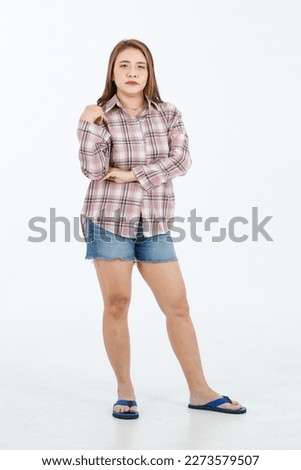 Portrait isolated cutout full body studio shot Asian cheerful happy female model in casual plaid long sleeves shirt shorts jeans and slippers standing crossed arms smiling posing on white background.