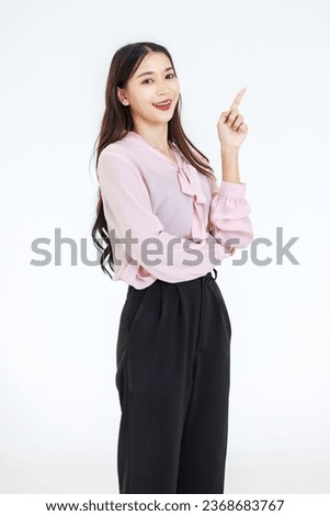 Portrait isolated cutout studio shot Asian professional successful female businesswoman manager entrepreneur in casual outfit standing smiling pointing empty space advertising on white background.