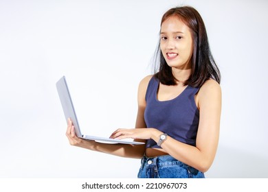 Portrait Isolated Studio Cutout Shot Of Asian Female Model Smiling Look At Camera Holding Pointing Green Blank Screen Laptop Computer Showing Product Promotion Advertisement On White Background.