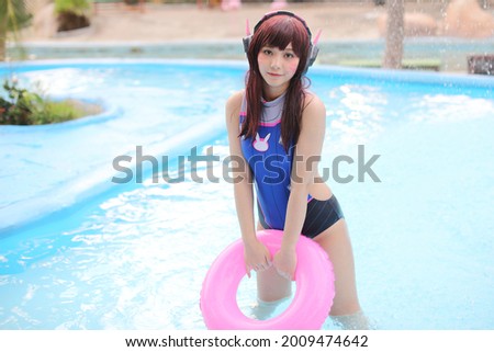 portrait of Japan anime cosplay girl with swim suit at swimming pool