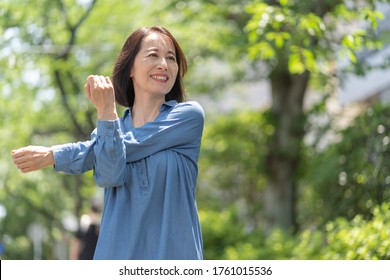 Portrait Of A Japanese Senior Outside
