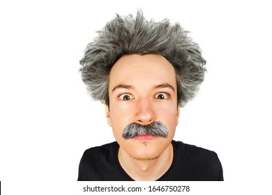 Portrait of jocular aging guy with grey long hair sticking his tongue out in Einstein manner. Isolated on background.