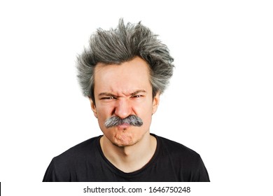 Portrait of jocular aging man with grey long hair wrinkles his nose from sour on his face in Einstein manner. Isolated on background.