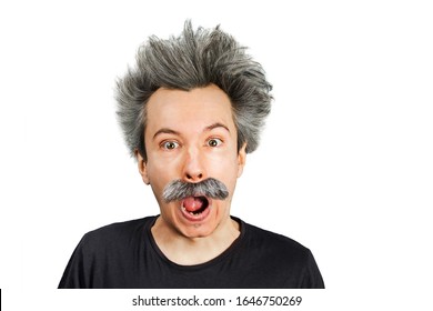 Portrait of jocular aging man with grey long hair sticking his tongue out in Einstein manner. Isolated on background.