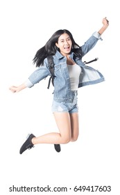 Portrait Of A Joyful Asian Woman Hiker Jumping In The Studio While Carrying A Backpack, Isolated On White Background, 20-28 Year Old.