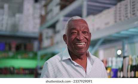 Portrait of a joyful Black Senior Brazilian man smiling at camera standing inside supermarket laughing - Powered by Shutterstock