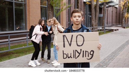 Portrait Of Joyful Teen Caucasian Boy Standing Outdoors With 