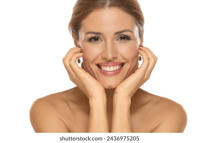 A portrait of a joyful woman with a beautiful smile and tasteful makeup,posing on white studio background, expressing happiness and confidence