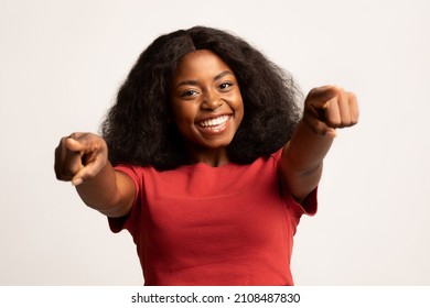 Portrait Of Joyful Young African American Female Pointing Two Fingers At Camera, Happy Positive Black Woman Indicating Somebody And Smiling, Standing Isolated On White Background, Copy Space