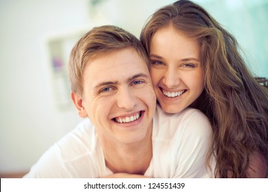 Portrait of joyful young people looking at camera and laughing