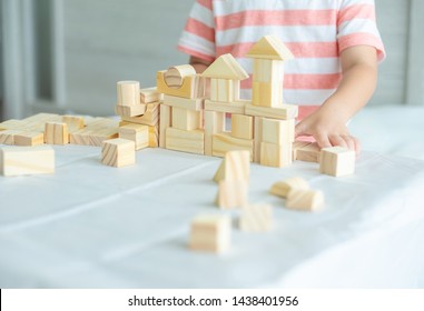 Portrait Of Kid Cute Asian Boy Playing A Blocks Wood Game. Selective Focus. Copy Space. Executive Functions Concept.