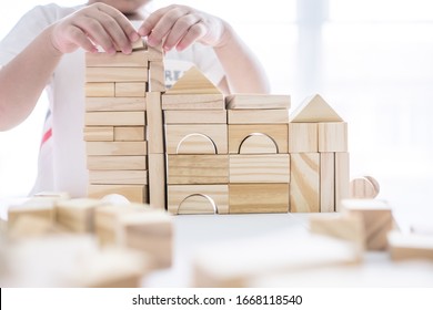 Portrait Of Kid Cute Asian Boy Playing A Blocks Wood Game. Selective Focus. Copy Space. Executive Functions Concept.