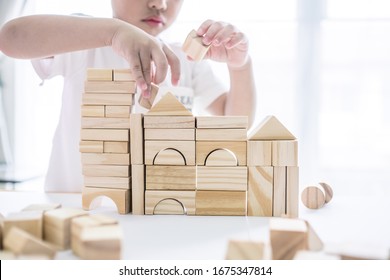 Portrait Of Kid Cute Asian Boy Playing A Blocks Wood Game. Selective Focus. Copy Space. Executive Functions Concept.