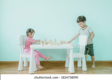 Portrait Of Kid Cute Asian Girl And Boy Playing A Blocks Wood Game. Selective Focus. Copy Space. Executive Functions Concept.