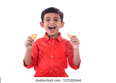 Portrait Of Kid Eating A Biscuit On White Background