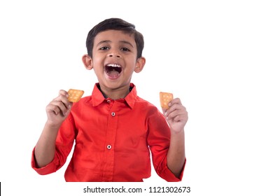 Portrait of kid eating a biscuit on white background