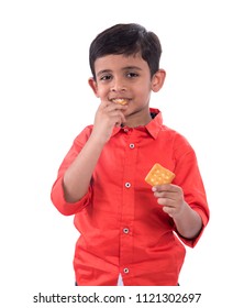 Portrait Of Kid Eating A Biscuit On White Background