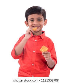 Portrait Of Kid Eating A Biscuit On White Background