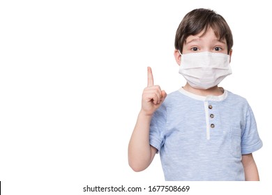 Portrait Of Kid With Face Mask Pointing Finger Up, Isolated On White Background