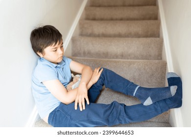 Portrait kid looking out deep in thought, Lonely Child sitting on stairs carpet with thinking face, Childhood and family concept, Selective focus Emotional kid image - Powered by Shutterstock