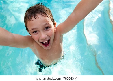 Portrait Of Kid Very Playful And Jumping In A Swimming Pool.