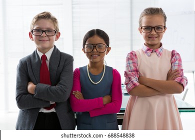 Portrait of kids as business executive smiling while standing in the office - Powered by Shutterstock