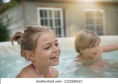 Portrait Of Kids Enjoying Hot Tub Water