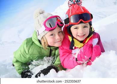 Portrait Of Kids Enjoying Winter Vacation At Ski Resort