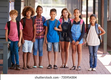 Portrait Of Kids Standing In Elementary School Hallway